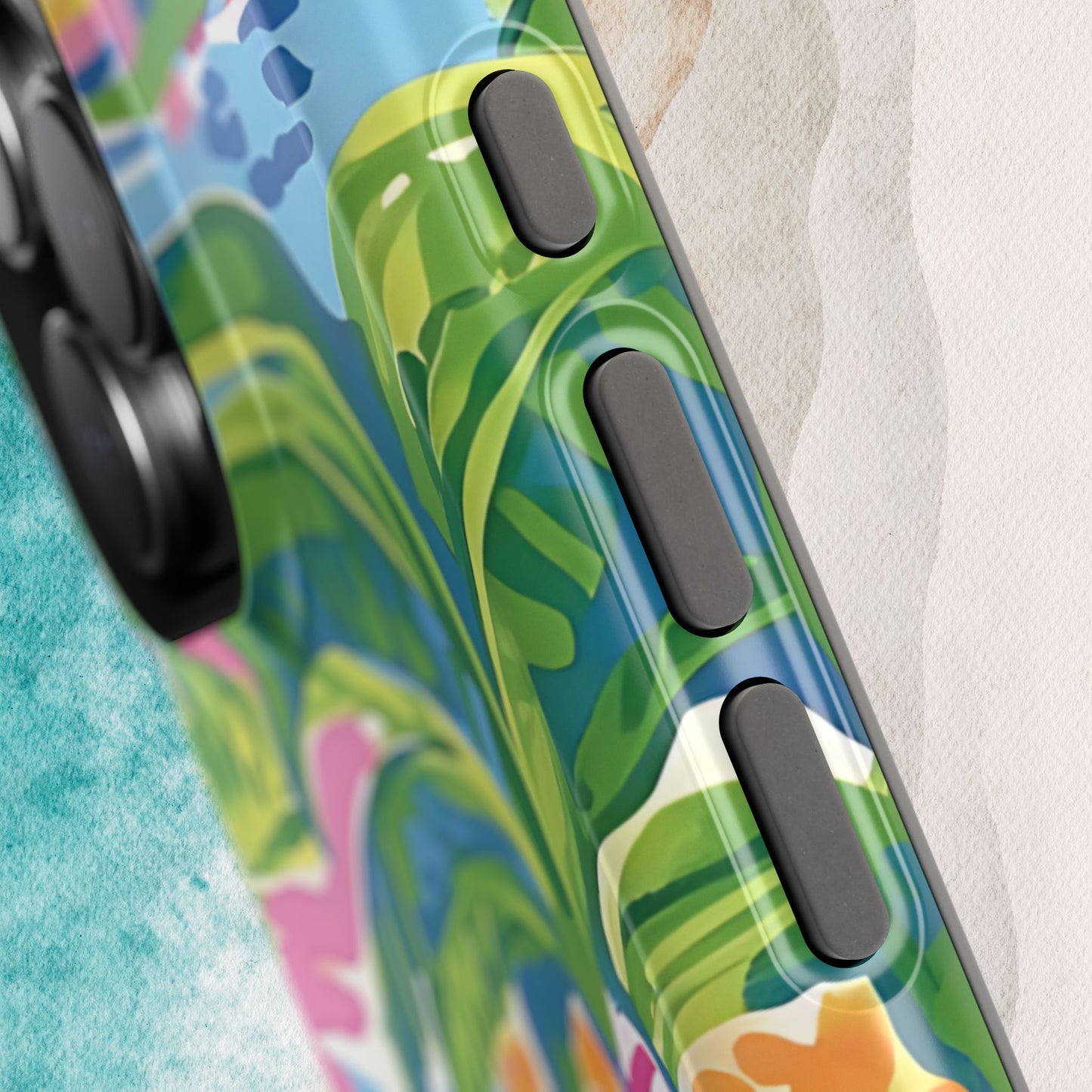 Close up view of Kiawah MagSafe Tough Case for iPhone with colorful leaf pattern on a textured surface