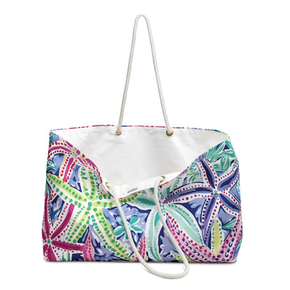 Siesta Key Weekender Tote Bag slightly opened to show cream lined interior and vibrant tropical exterior on a white background.