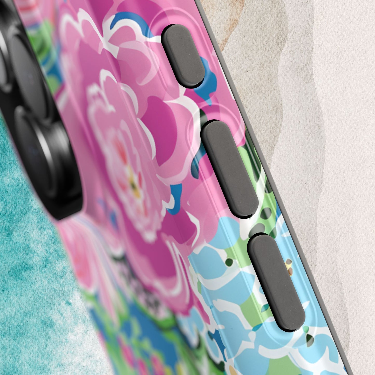 Phone case with colorful floral design on a textured surface