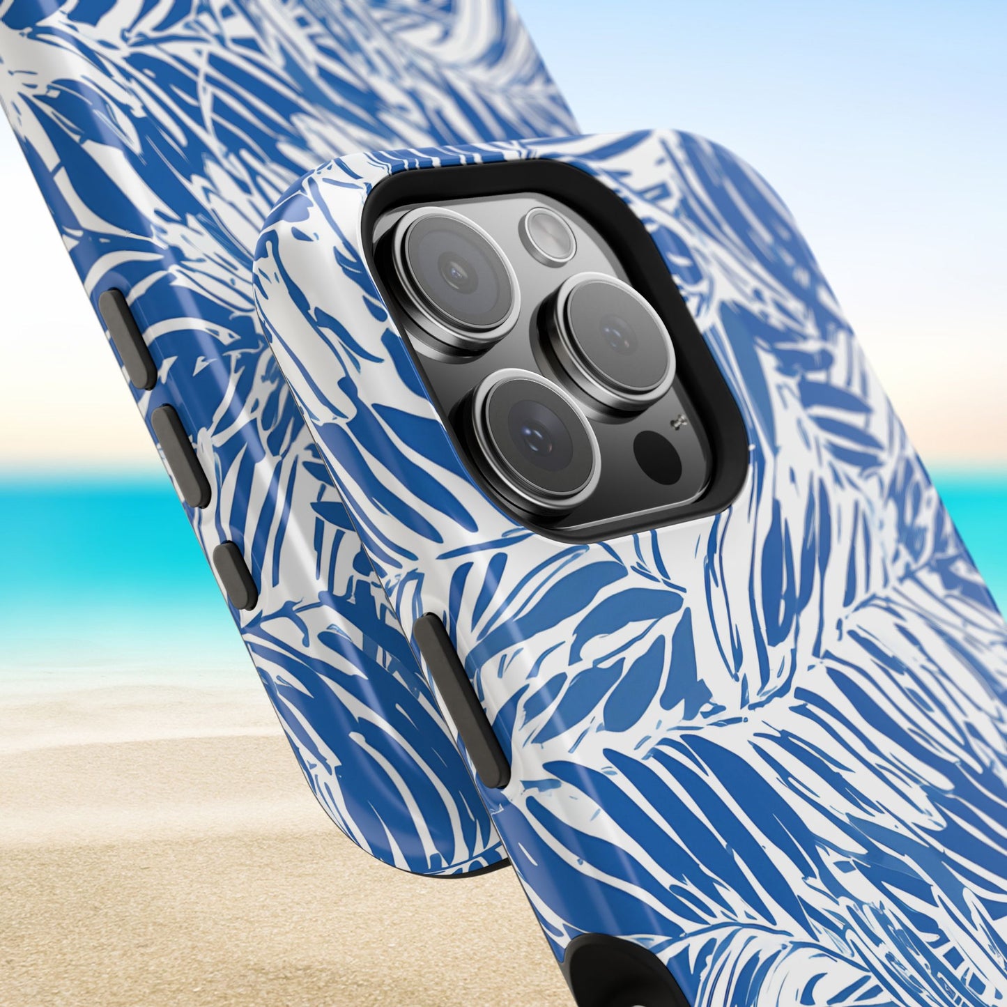 Blue and white palm leaf patterned Hampton MagSafe Tough Case for iPhone with a beach background