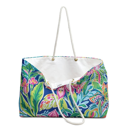Vibrant floral-patterned tote bag with white rope handles on a white background
