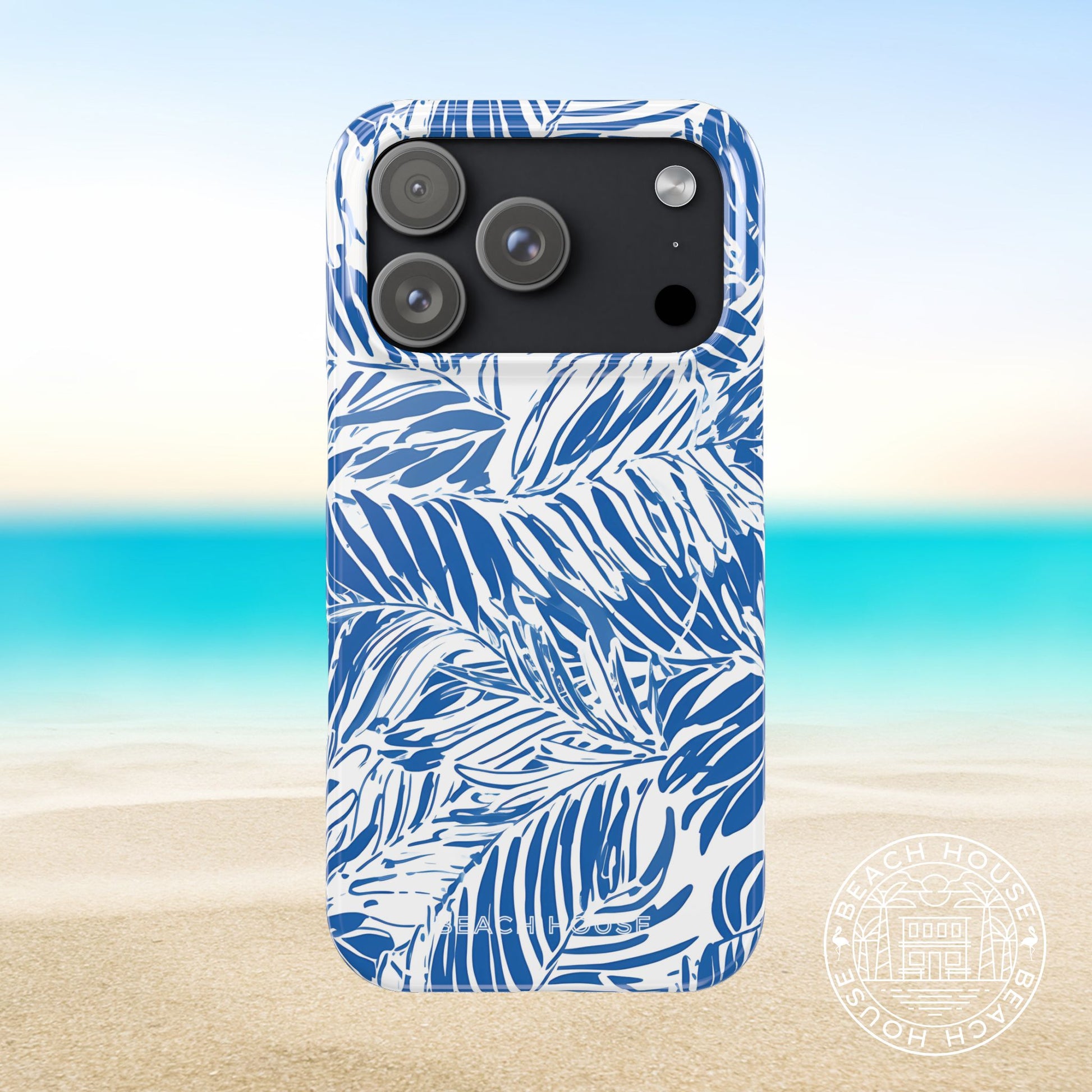 Hampton Slim Case for iPhone 17 Pro with blue palm leaf pattern on a beach background