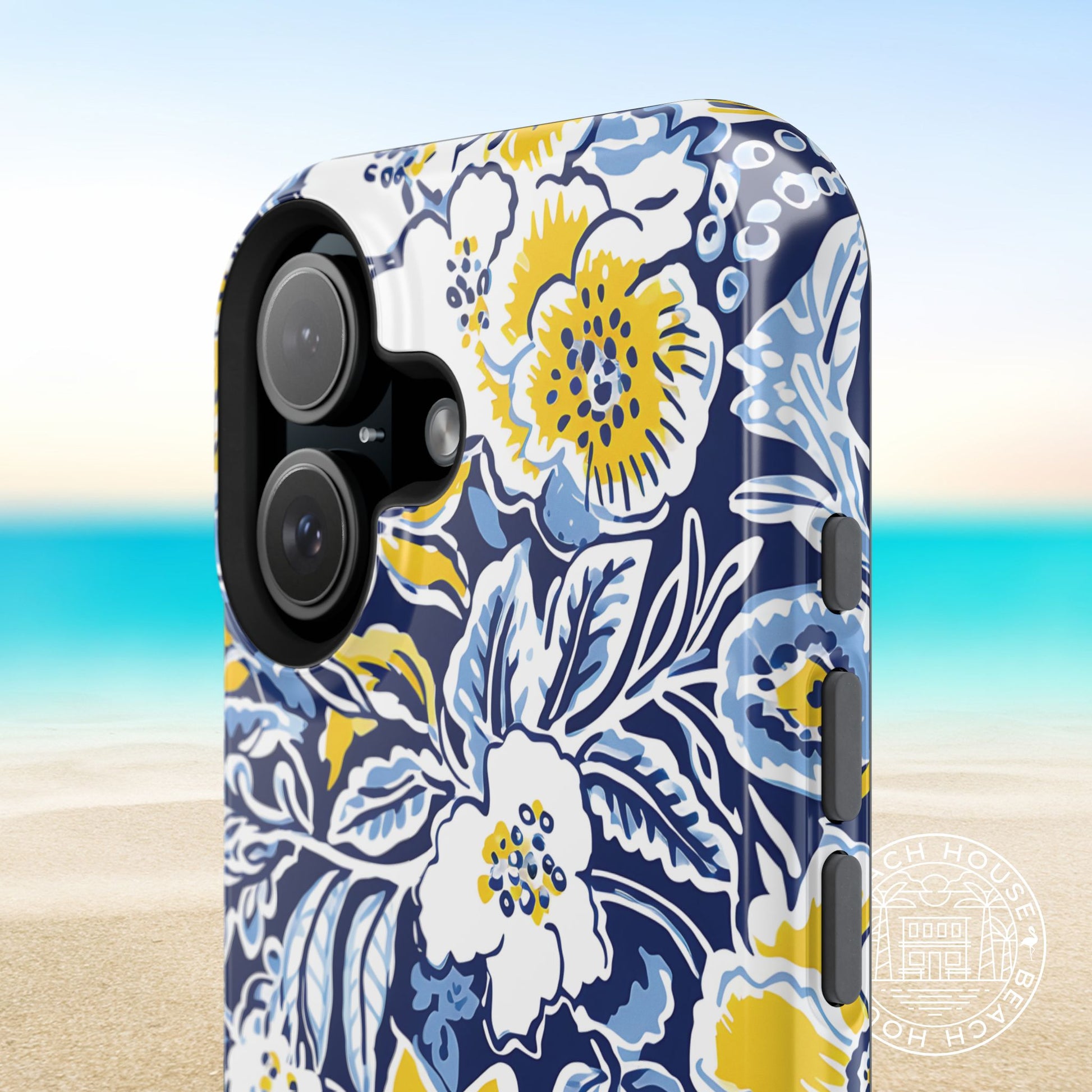 Ann Arbor MagSafe Tough Case for iPhone case with blue, yellow, and white colors on a blurred beach background
