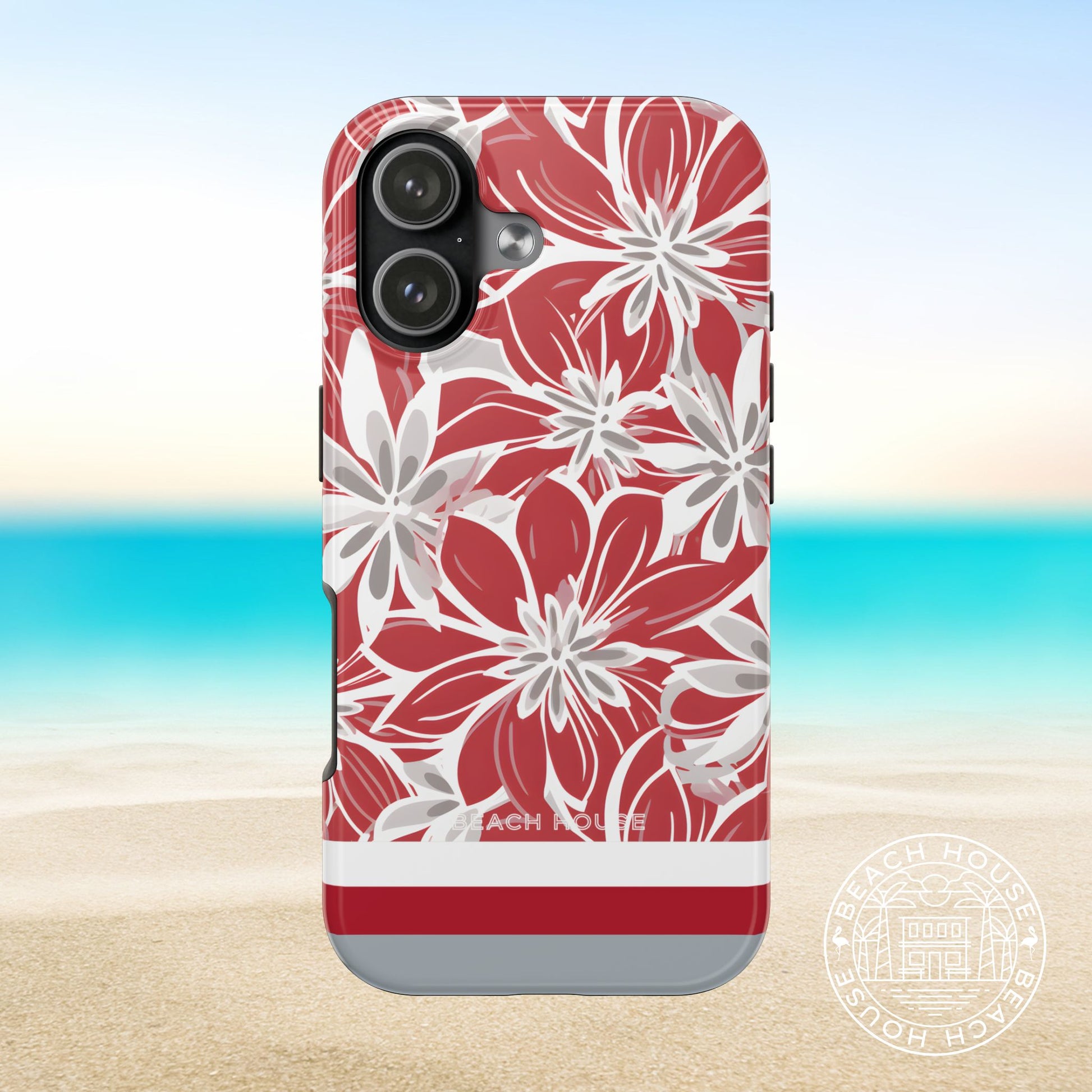 Columbus Tough case for iPhone 17 with red and white floral pattern on a beach background