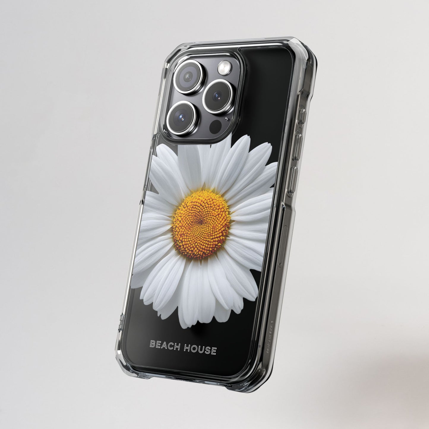 Phone case with a daisy design on a gray background