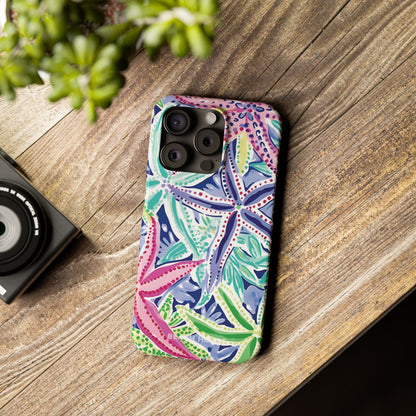 Colorful Siesta Key Slim Case for iPhone on a wooden surface with a camera and plant in the background