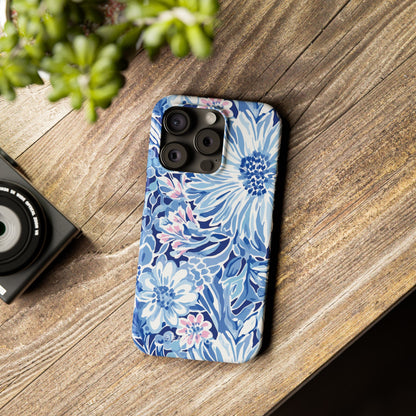 Huntington Slim Case for iPhone on a wooden surface with a camera and plant in the background