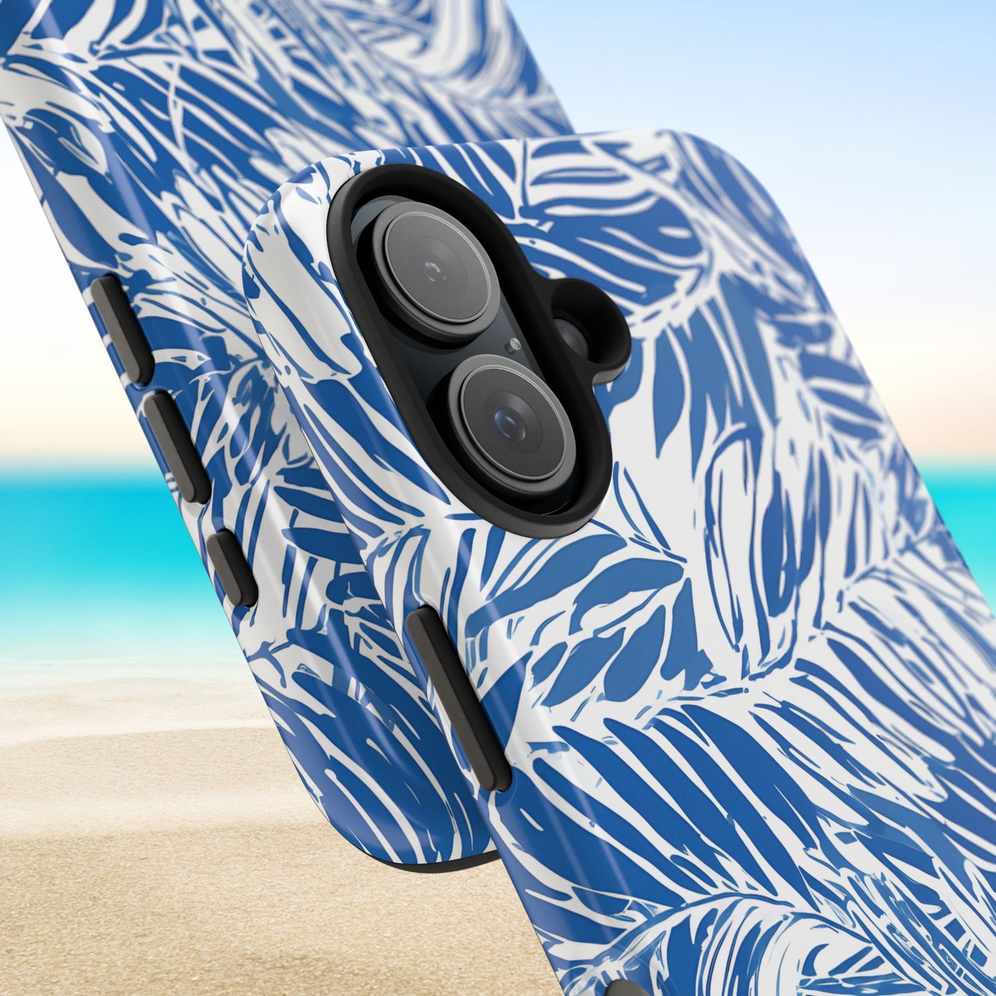 Hampton Tough Case for iPhone with blue and white palm leaf pattern on a beach background