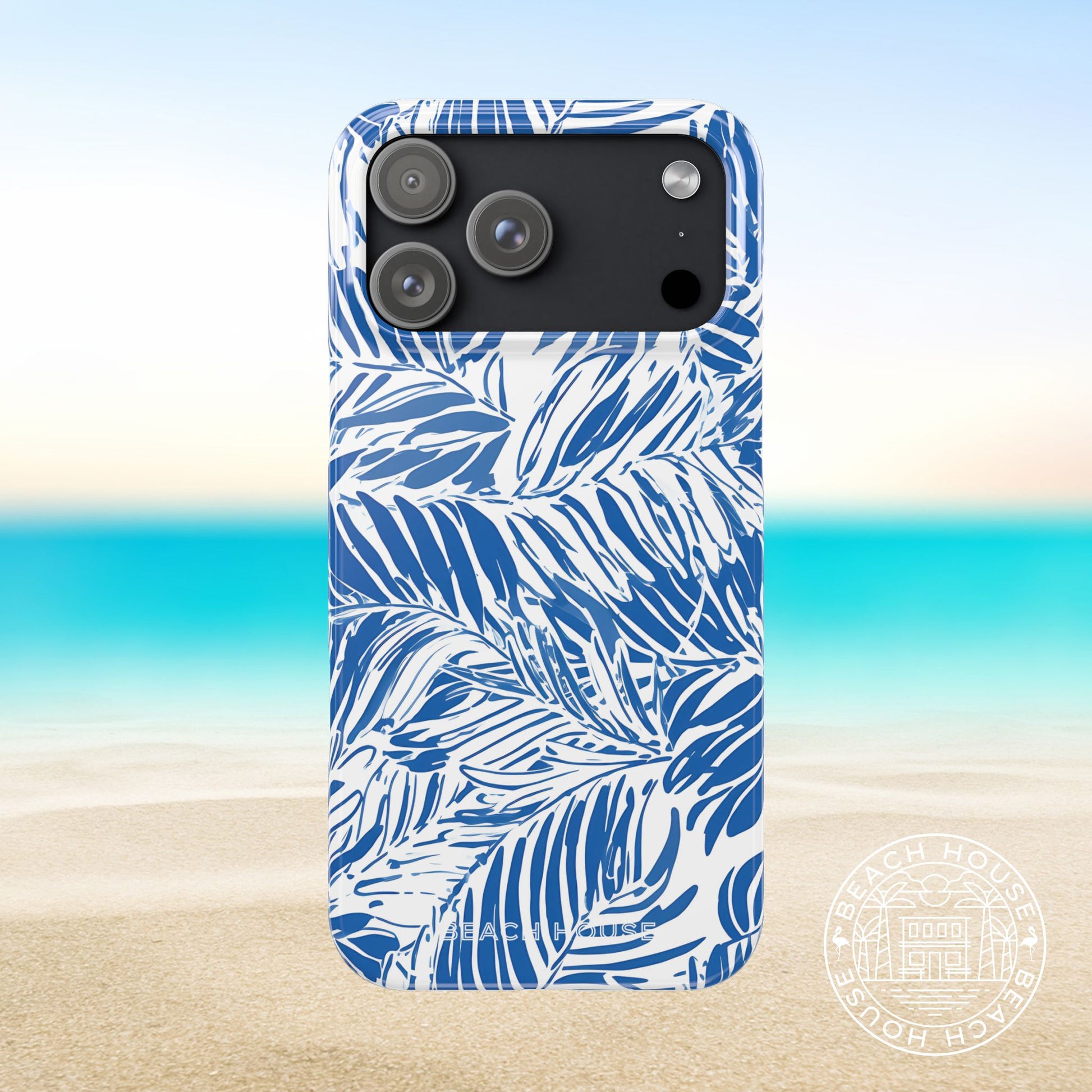 Hampton Slim Case for iPhone 17 Pro Max with blue leaf pattern on a beach background