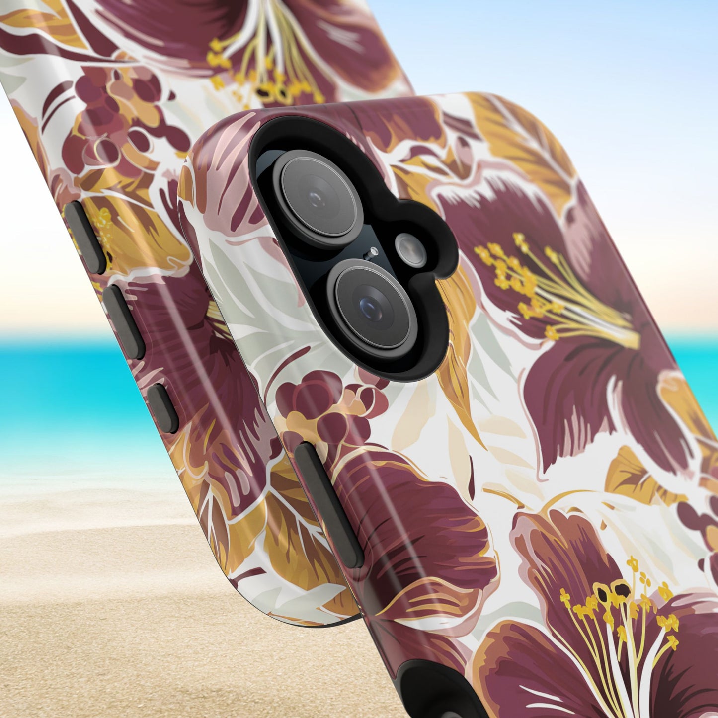 Close up views of the Tallahassee MagSafe Tough Case for iPhone with floral design on a beach background