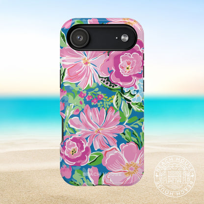 Madeira MagSafe Tough Case for iPhone 17 Air with pink flowers on a blue background, placed on a beach setting.