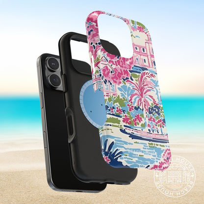 Layers of the Amelia MagSafe Tough Case for iPhone with floral design and coastal illustration, next to a phone, on a beach background