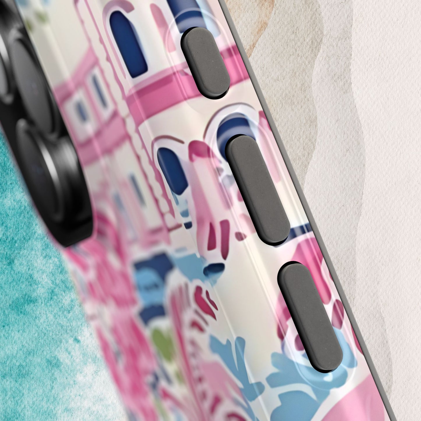 Close up view of buttons on the Amelia MagSafe Tough Case for iPhone with colorful design on a textured surface