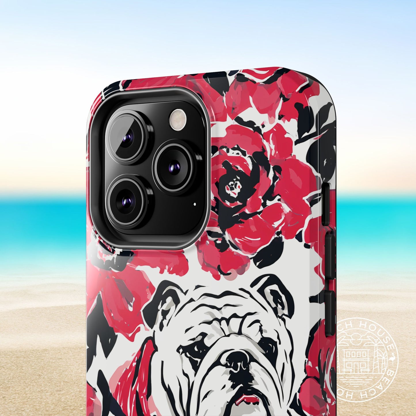 Close up view of the Athens Tough Case for iPhone with bulldog and floral design on a beach background