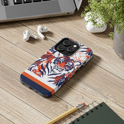 Auburn Tough Case for iPhone with tiger design on a wooden surface with laptop, earbuds, and notebook.