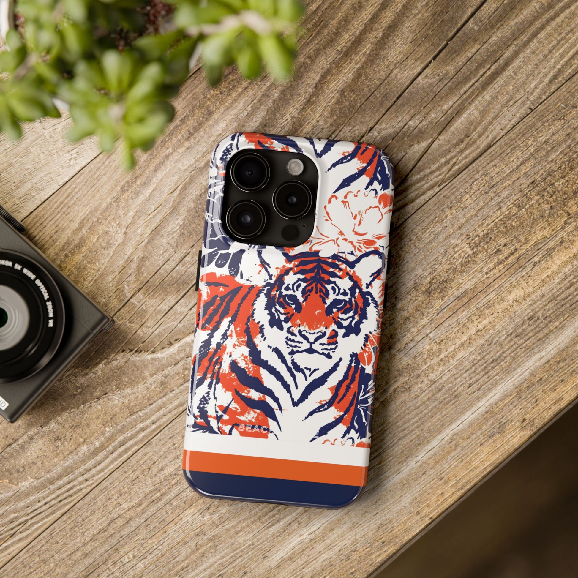 Auburn Tough Case for iPhone with tiger design on a wooden surface