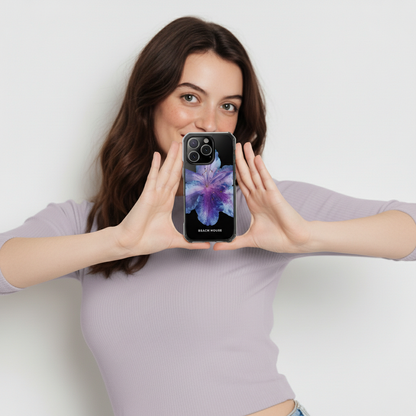 Woman holding a phone with a colorful case against a plain background
