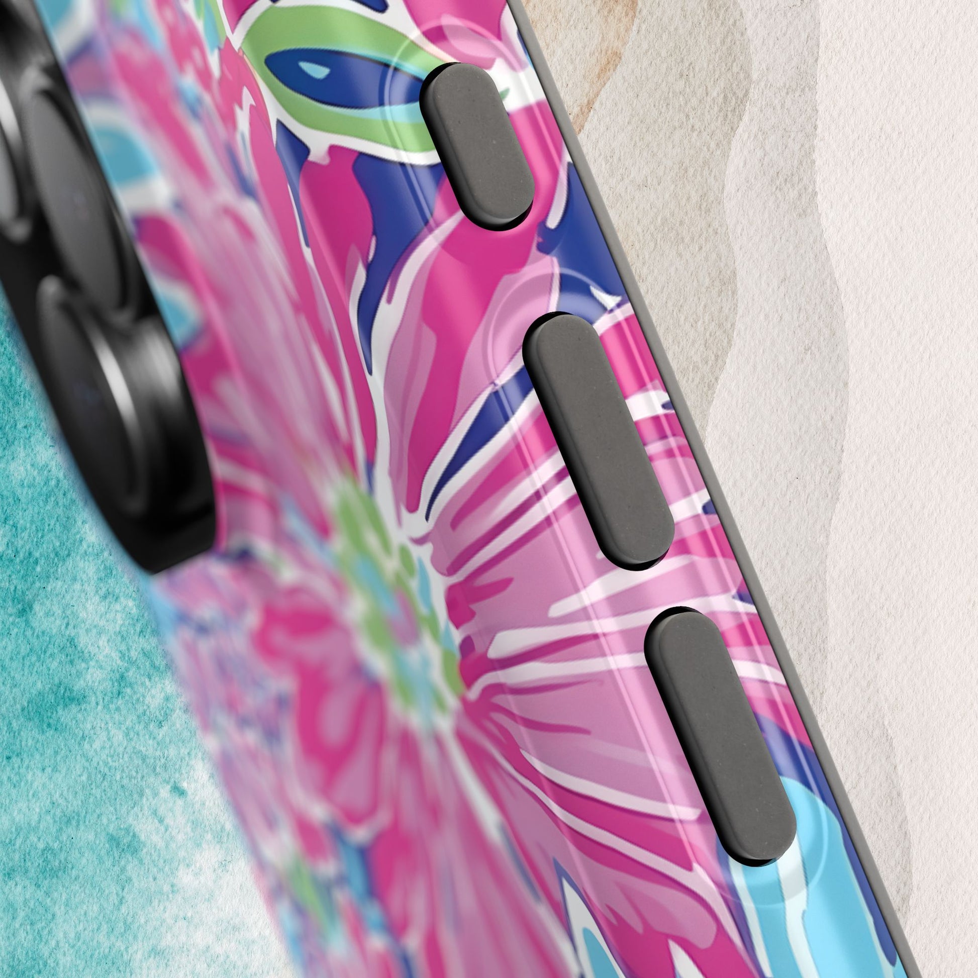 Close up view of buttons on the Bimini MagSafe Tough Case for iPhone with tropical design on a textured surface