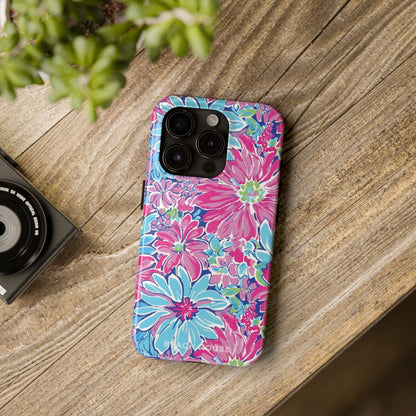 Floral Bimini Tough Case for iPhone on a wooden surface with a camera and plant in the background