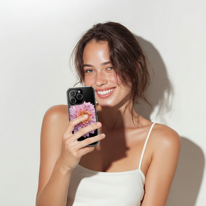 Woman holding a phone with a floral case against a white background