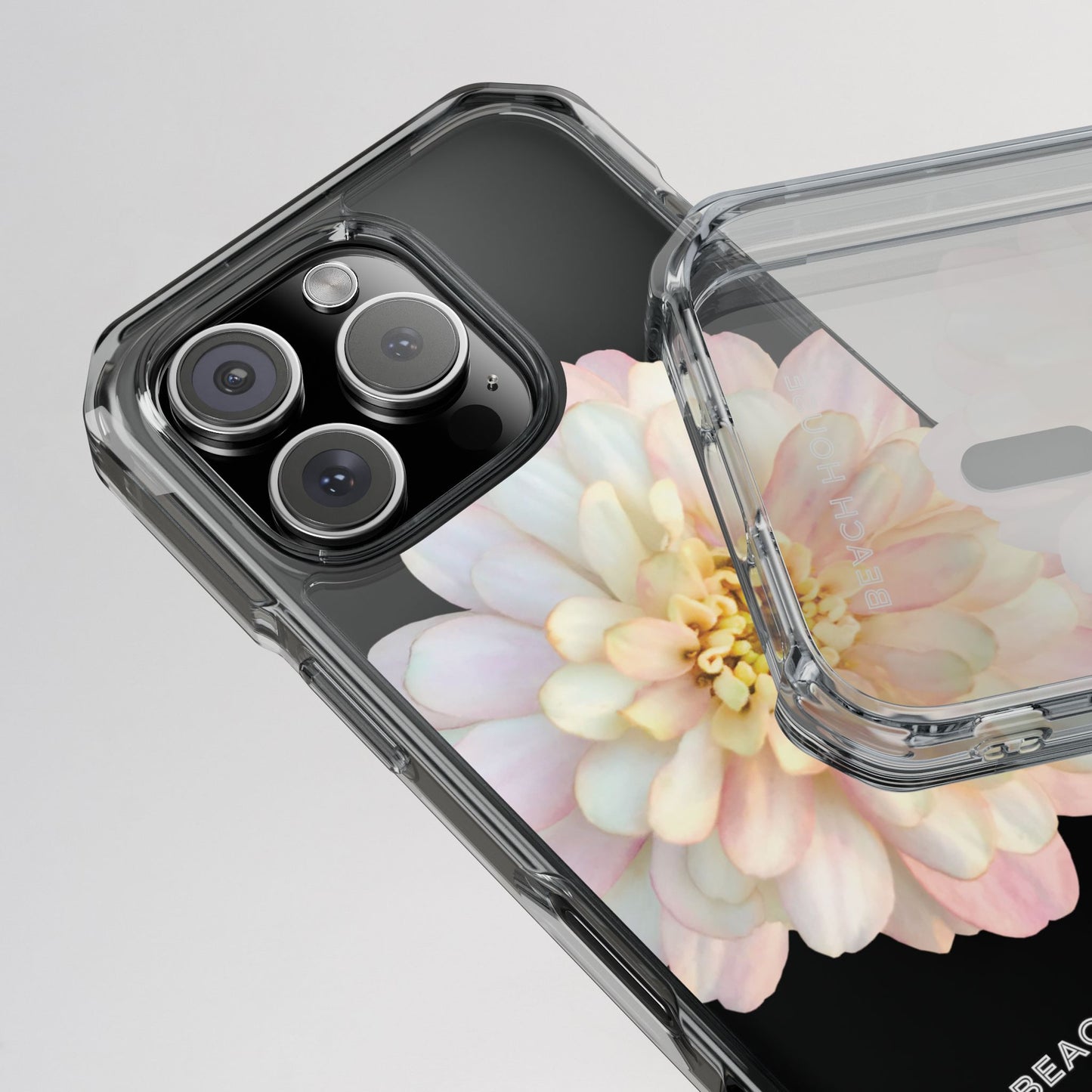 Phone case with floral design and camera details on a light gray background