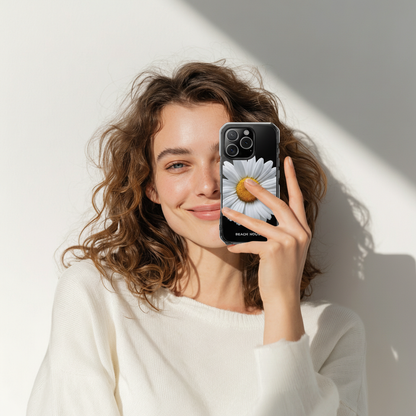 Woman holding a phone with a floral Beach House case against a light background