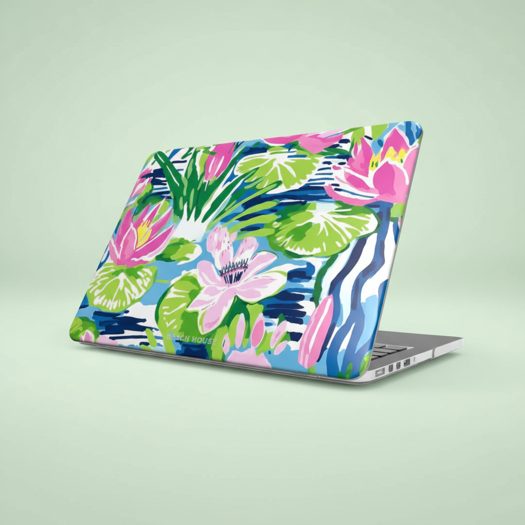 Laptop with a colorful floral Everglades MacBook Case on a light green background