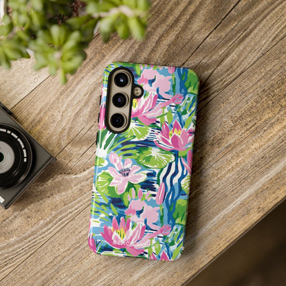 Colorful floral phone Everglades Tough Case for Galaxy on a wooden surface with a camera and plant in the background