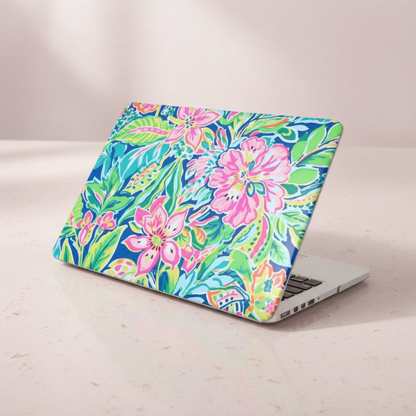 Fernandina MacBook Case with a colorful floral design on a light wooden surface