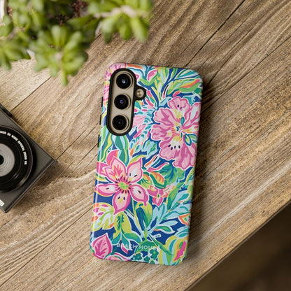 Colorful floral Fernandina Tough Case for Galaxy on a wooden surface with a camera and plant in the background