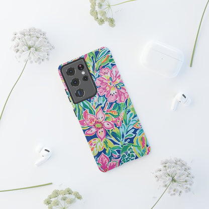 Fernandina Tough Case for Galaxy with colorful floral design on a white surface with earbuds and flowers nearby