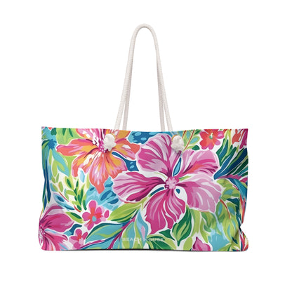 Front view of a floral patterned Waikiki bag with pink and green flowers on a white background
