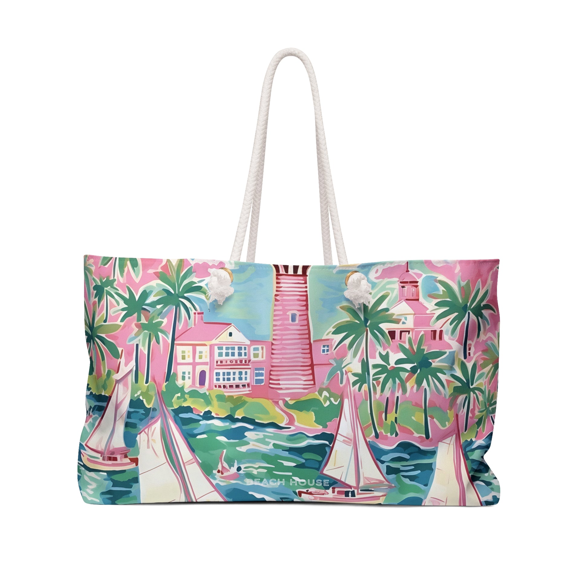Front side of the St. Simon Weekender tote bag with a tropical scene featuring sail boats, palm trees and a lighthouse.