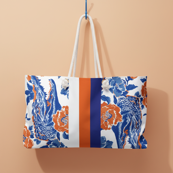 Gainesville Weekender tote bag with floral  and alligator pattern and color block design on a orange background