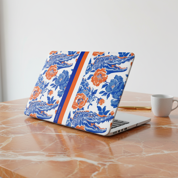 Laptop with a Gainesville MacBook Case on a marble desk