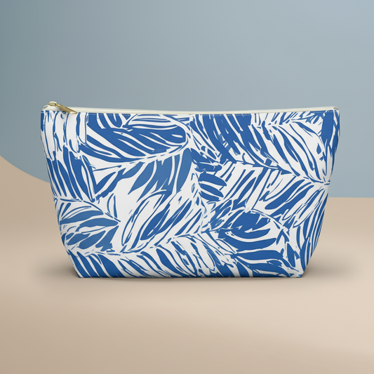 Blue and white patterned pouch on a beige surface with a gray background