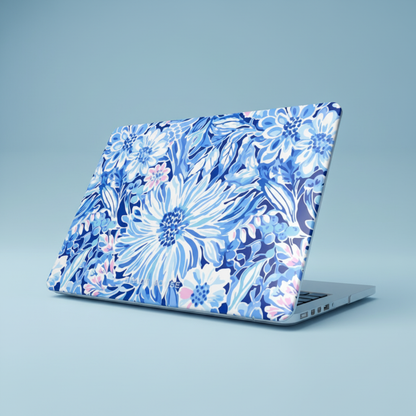 Laptop with a blue floral Huntington case for MacBook on a light blue background