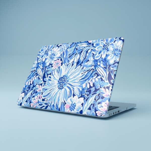 Laptop with a blue floral Huntington case for MacBook on a light blue background