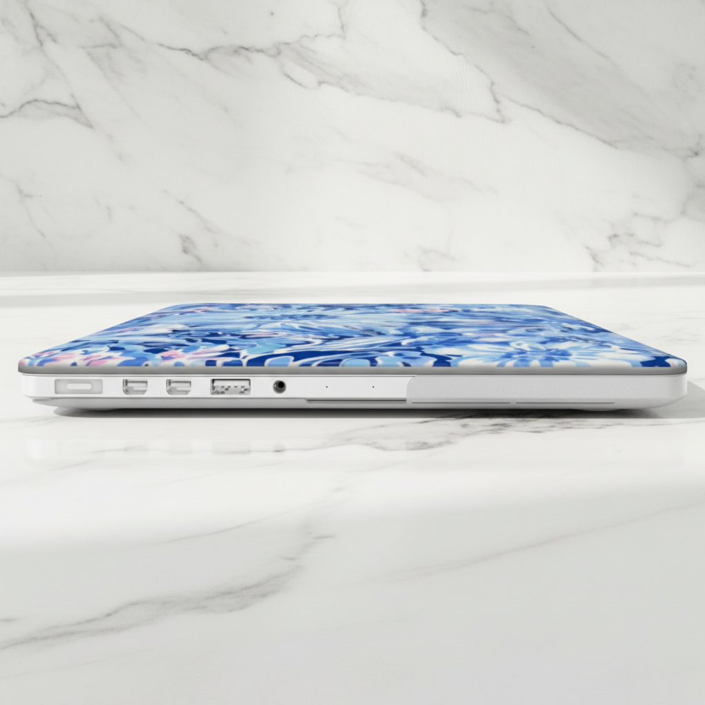 Laptop with a blue floral Huntington MacBook case on a marble surface