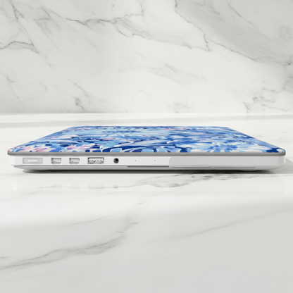 Laptop with a blue floral Huntington MacBook case on a marble surface