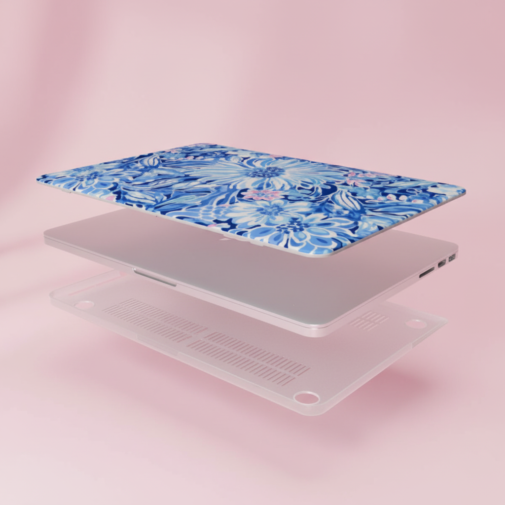 Laptop with a blue floral Huntington MacBook case on a pink background