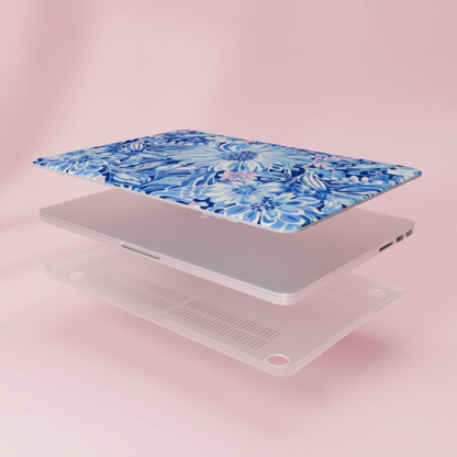 Laptop with a blue floral Huntington MacBook case on a pink background