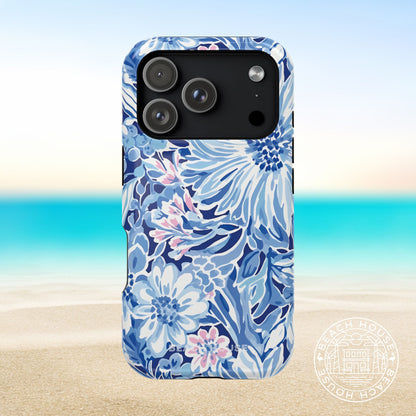 Blue floral Huntington MagSafe Tough phone case for iPhone 17 Pro on a beach background