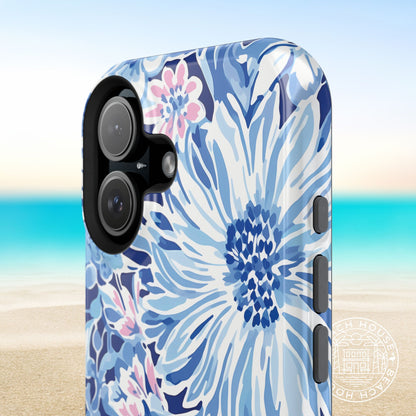 Close up of the Huntington MagSafe Tough Phone case with blue floral design on a beach background