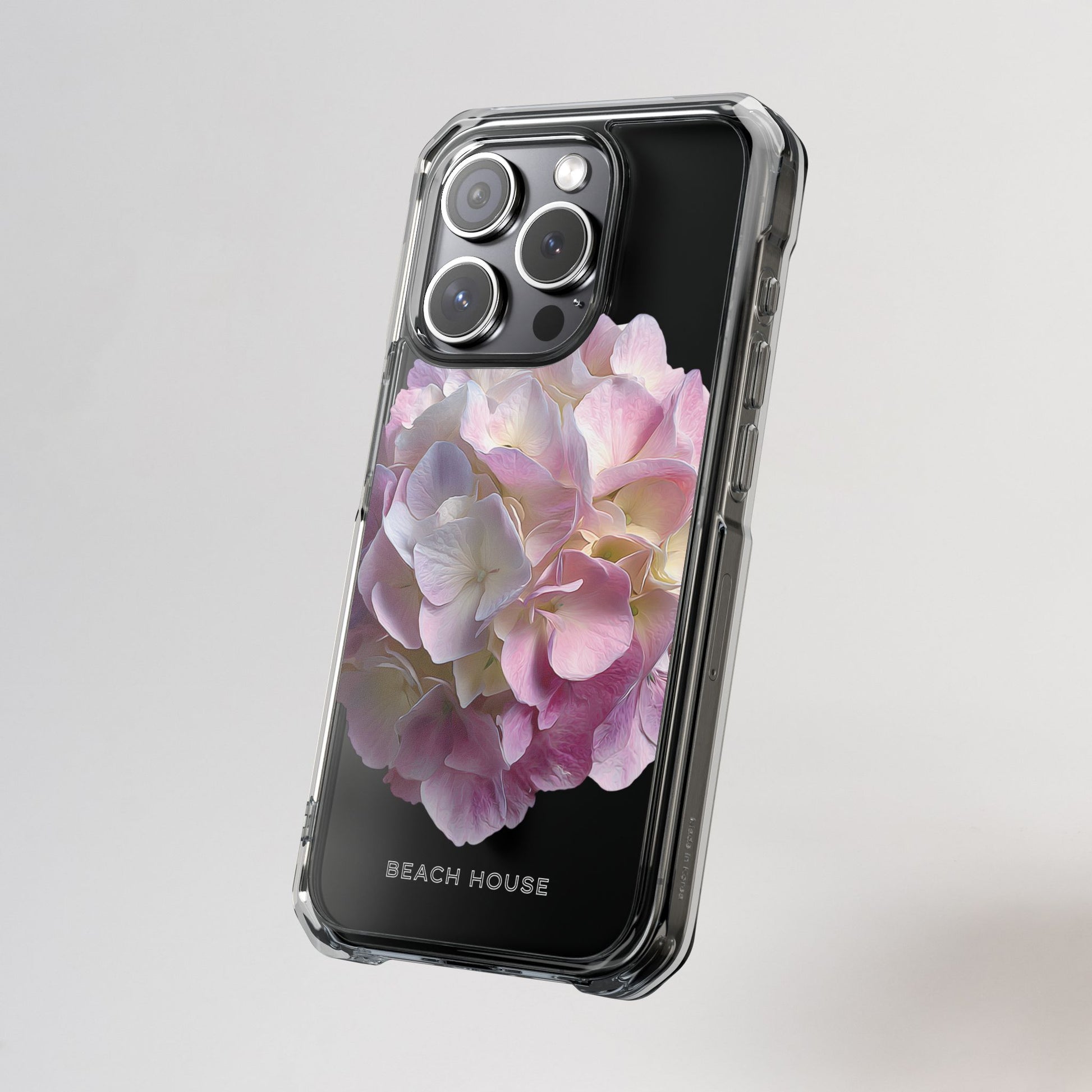 Phone case with pink floral design on a gray background