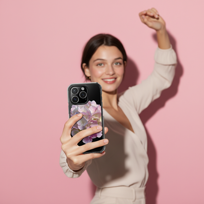 Woman holding a phone with a floral case against a pink background