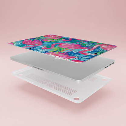 Top and bottom layers of the Key Largo MacBook case, next to a laptop on a pink background