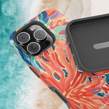 Phone case with colorful coral design and black back on a textured surface