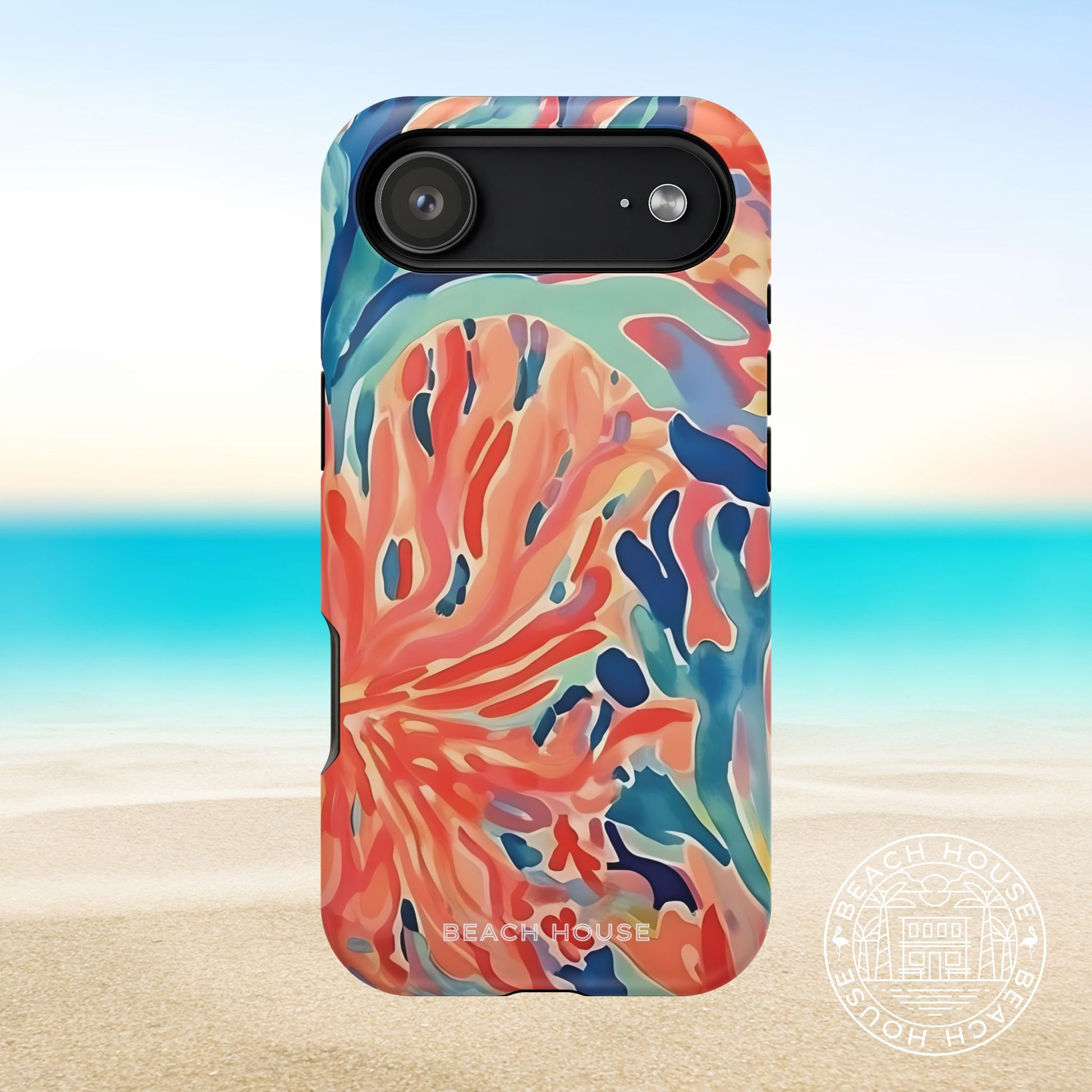 Colorful coral-patterned phone case on a beach background