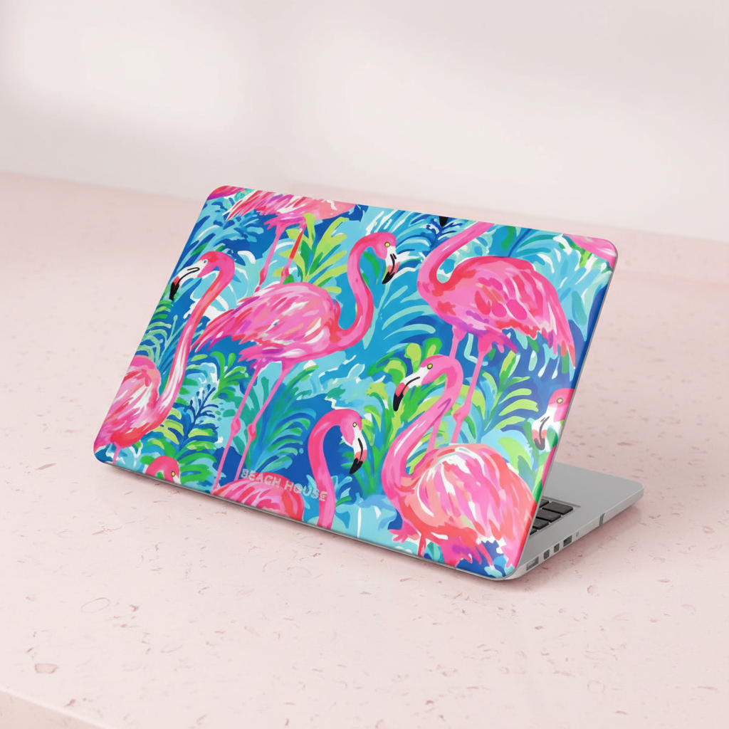 Laptop with a colorful flamingo Key Largo MacBook Case on a light wooden surface